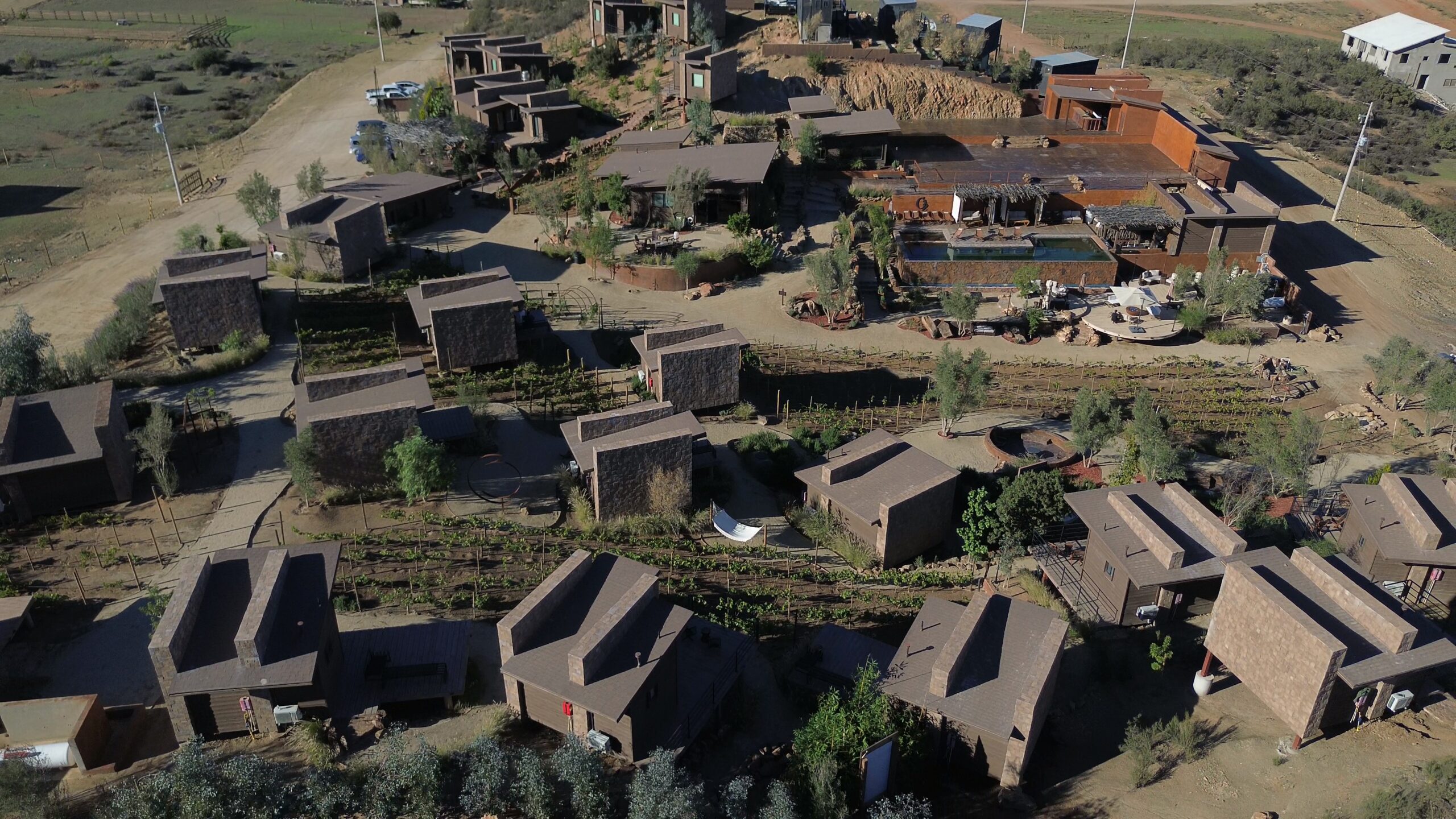 Aerial drone view of luxury cabins at O2 Resort Valle de Guadalupe surrounded by the scenic landscape of Baja California wine country