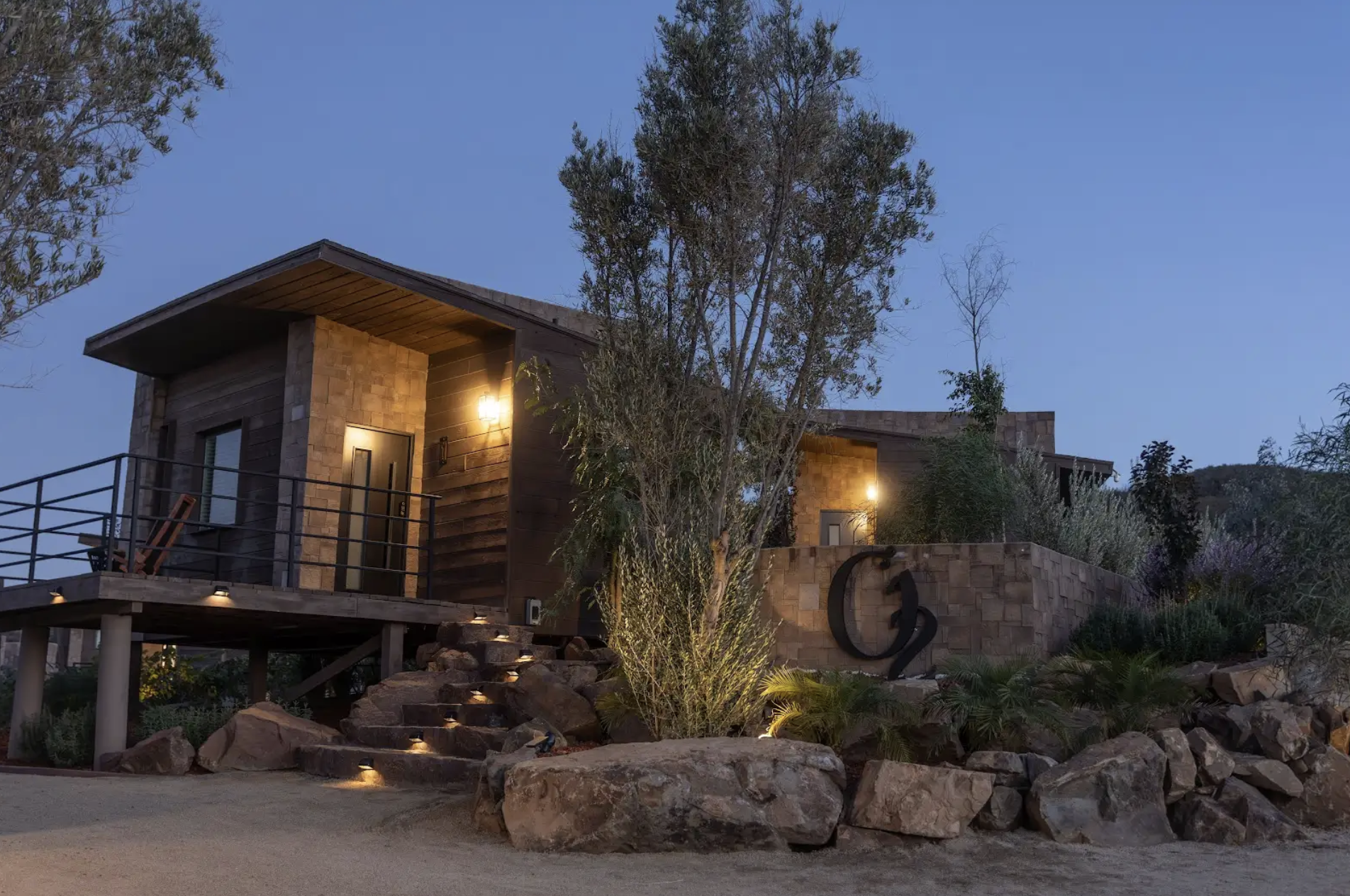 Exterior night view of a luxury cabin at O2 Resort Valle de Guadalupe featuring a peaceful illuminated setting in Baja California wine country