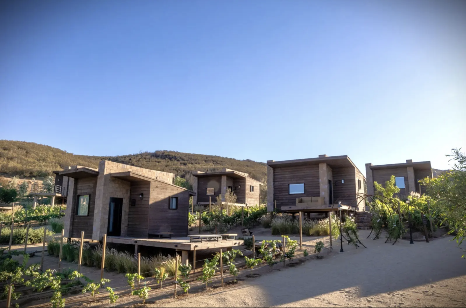 View of luxury cabins at O2 Resort Valle de Guadalupe surrounded by the scenic natural landscape of Baja California wine country