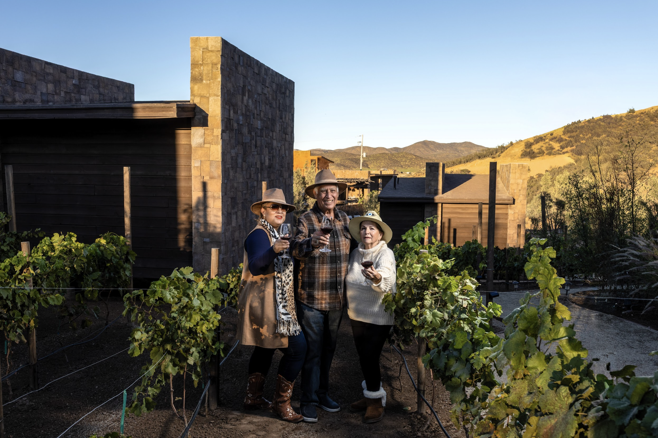 Three guests enjoying time together at O2 Resort Valle de Guadalupe surrounded by the relaxing atmosphere of Baja California wine country