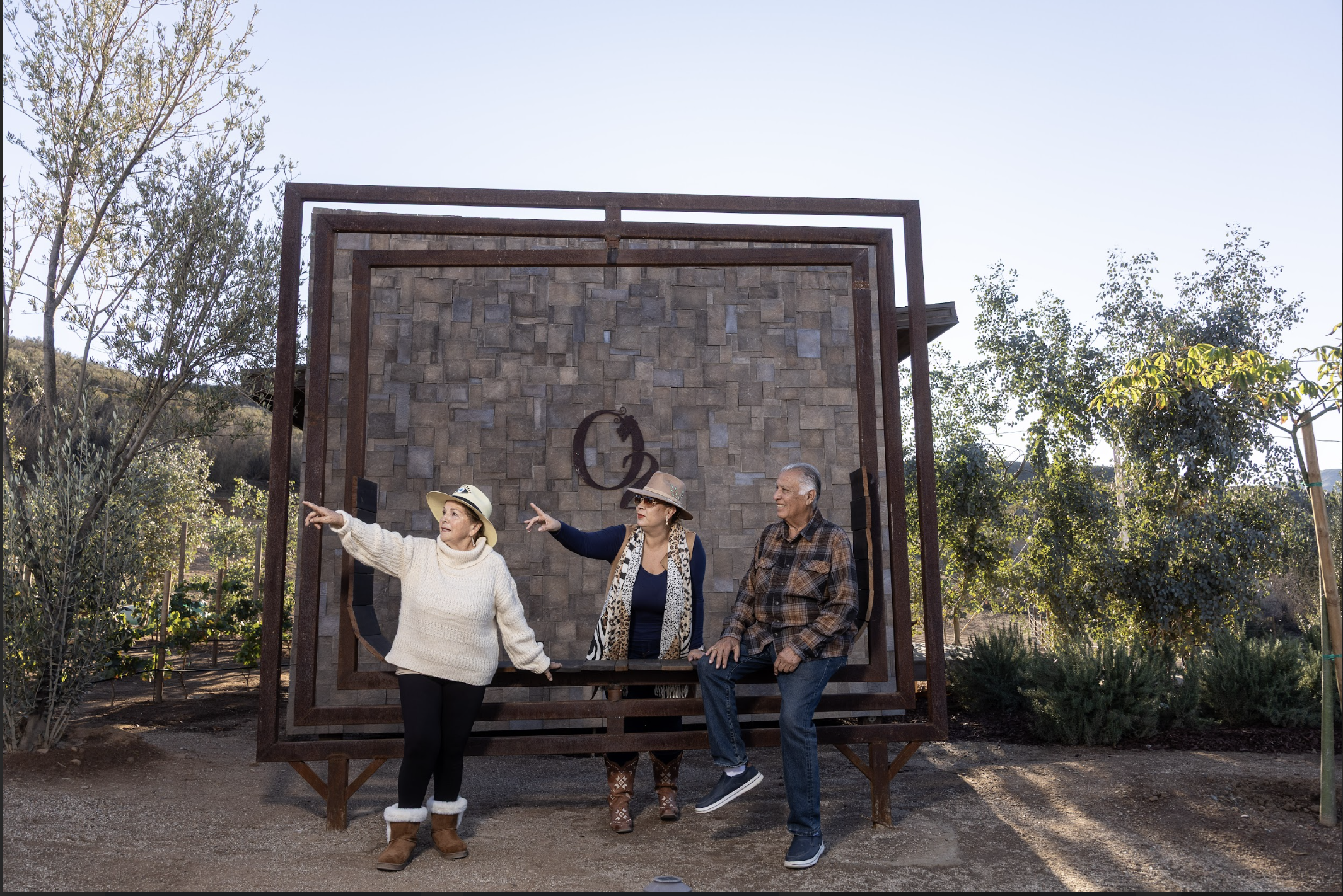 Three guests relaxing together at O2 Resort Valle de Guadalupe while enjoying the peaceful atmosphere of Baja California wine country