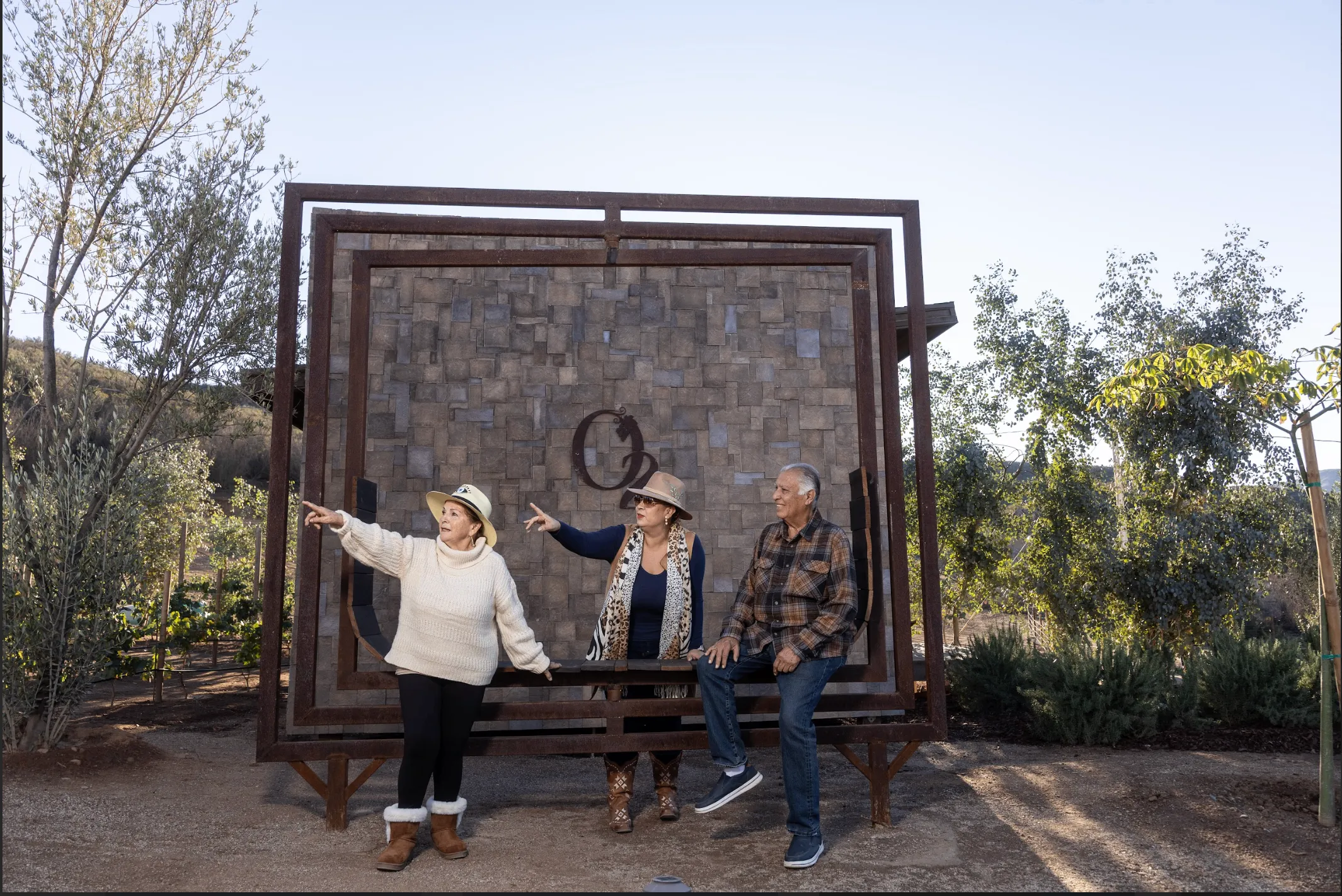 Three guests relaxing together at O2 Resort Valle de Guadalupe while enjoying the peaceful atmosphere of Baja California wine country