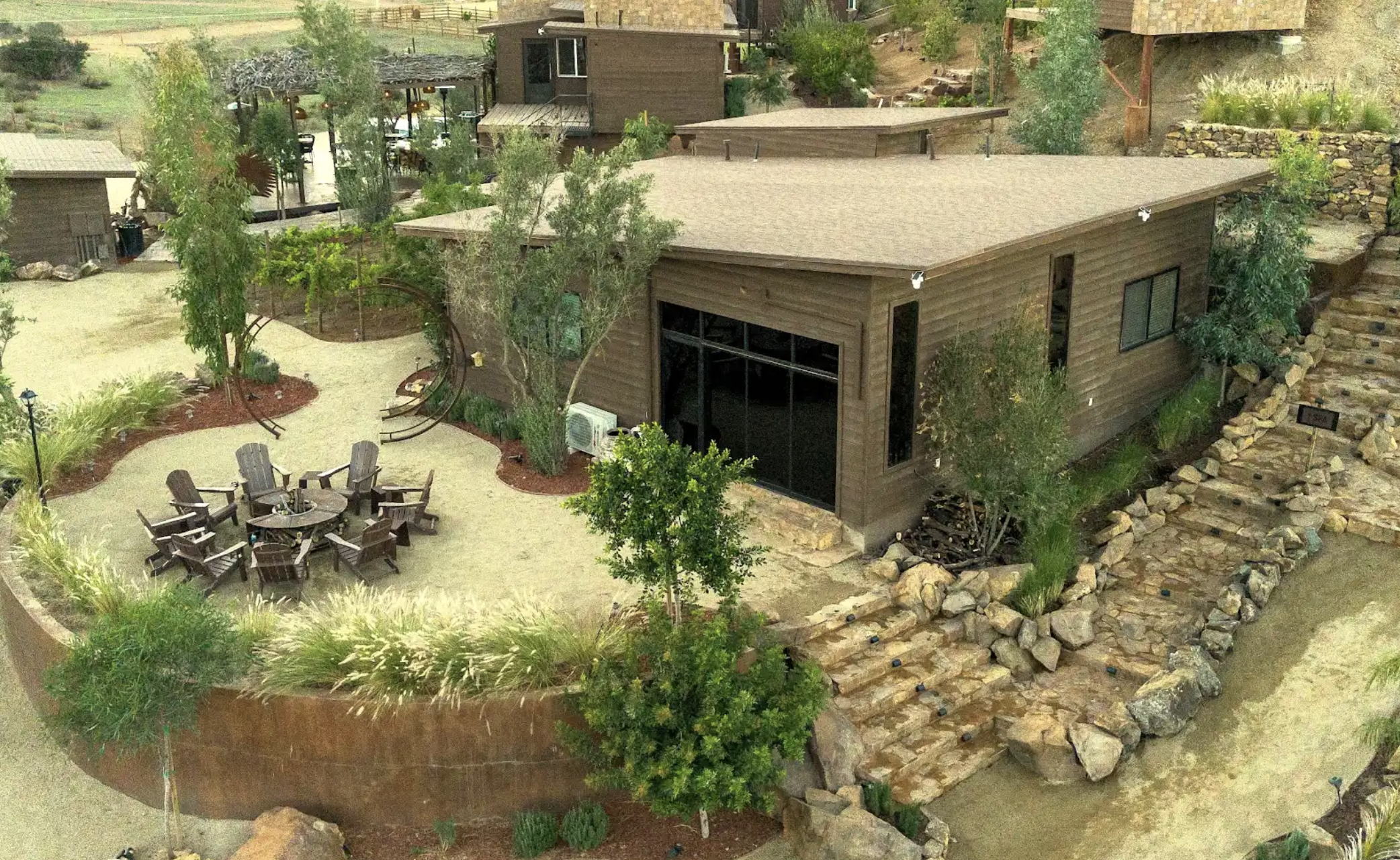 Aerial drone view of luxury cabins at O2 Resort Valle de Guadalupe surrounded by the natural landscape of Baja California wine country