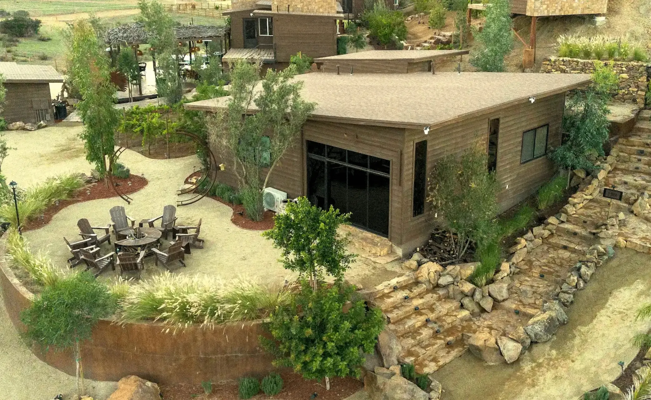 Aerial drone view of luxury cabins at O2 Resort Valle de Guadalupe surrounded by the natural landscape of Baja California wine country