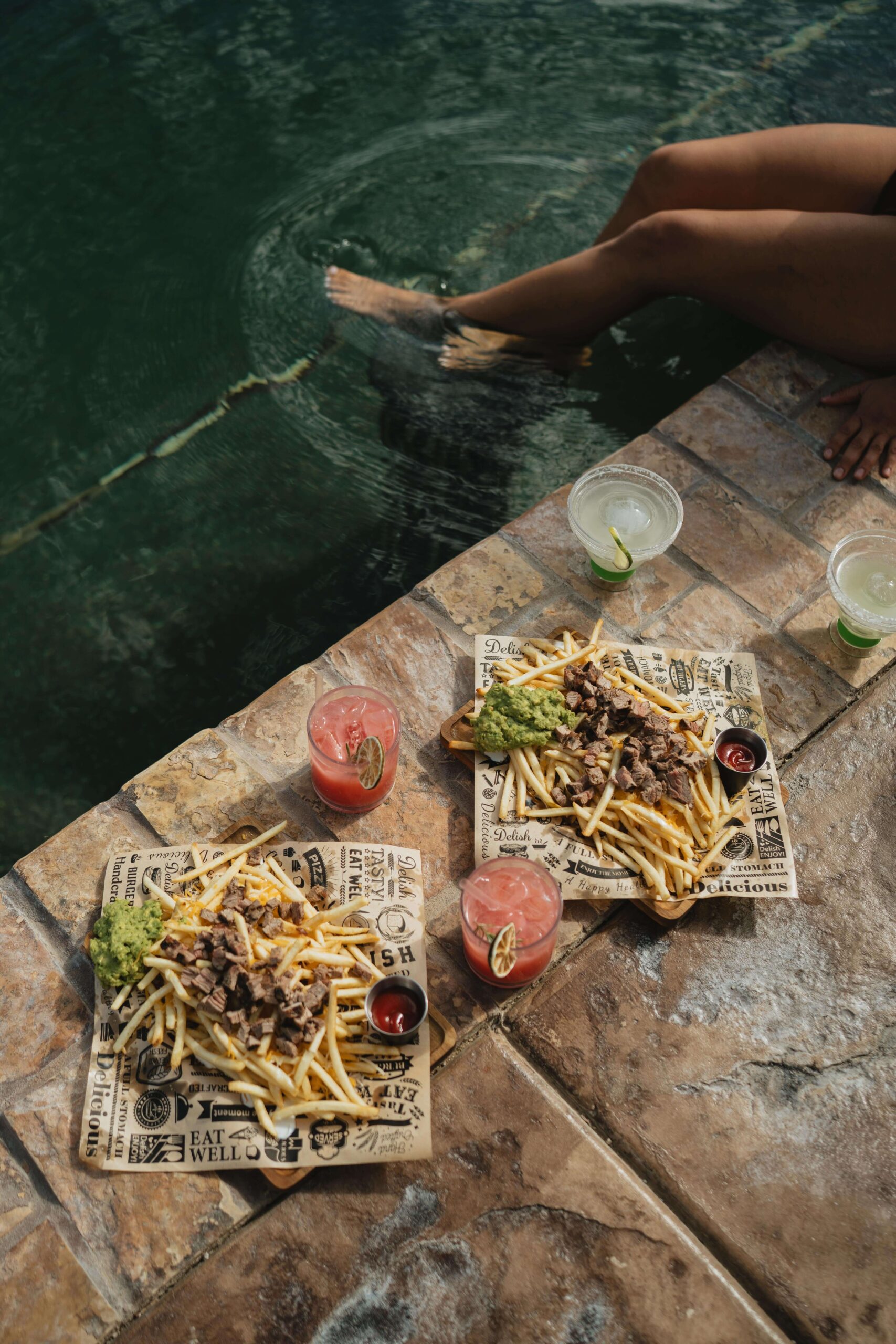 Poolside food and drinks at O2 Resort Valle de Guadalupe featuring gourmet cuisine, handcrafted cocktails, and scenic vineyard views in Baja California