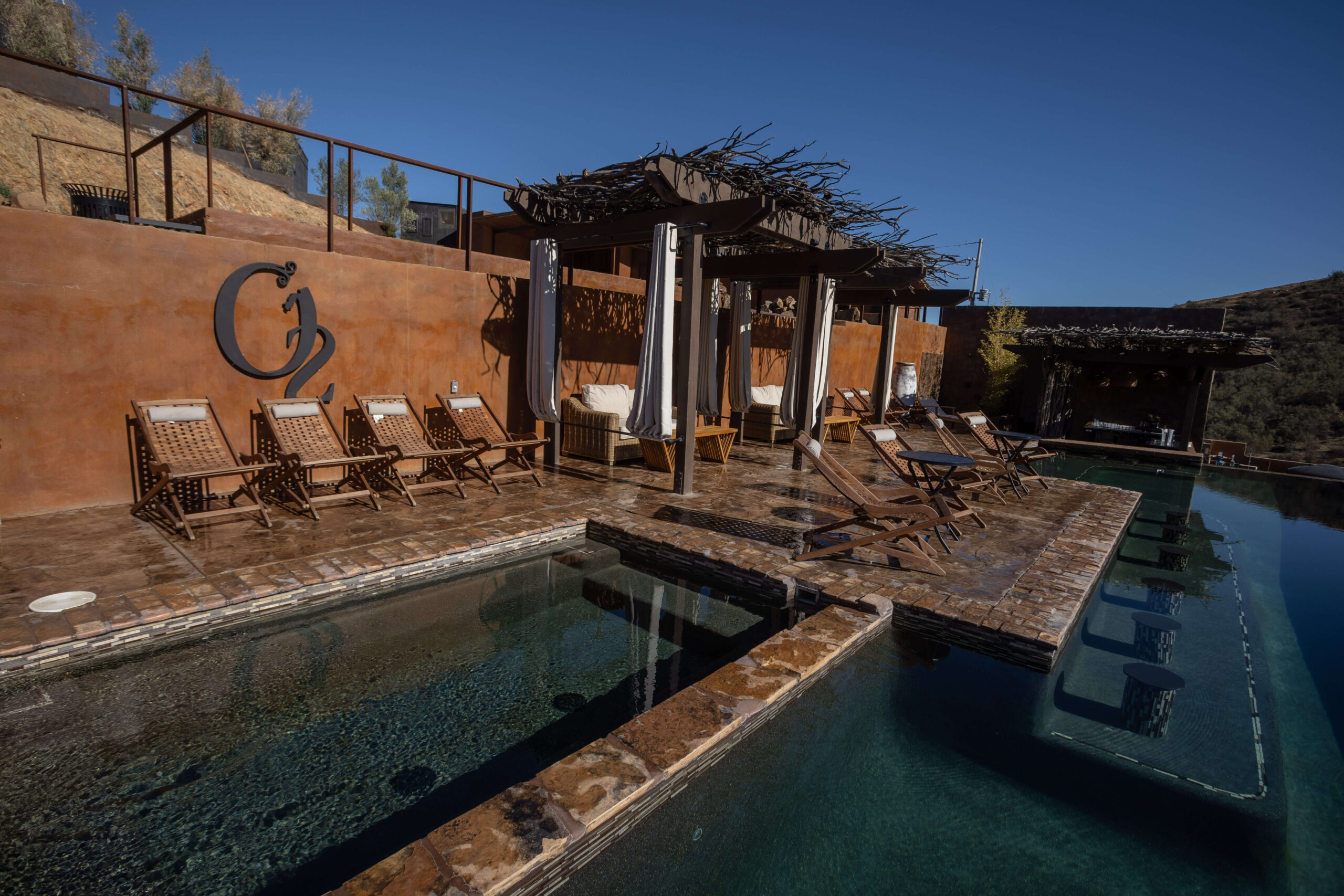 Luxury infinity pool at O2 Resort Valle de Guadalupe overlooking the scenic vineyards of Baja California wine country